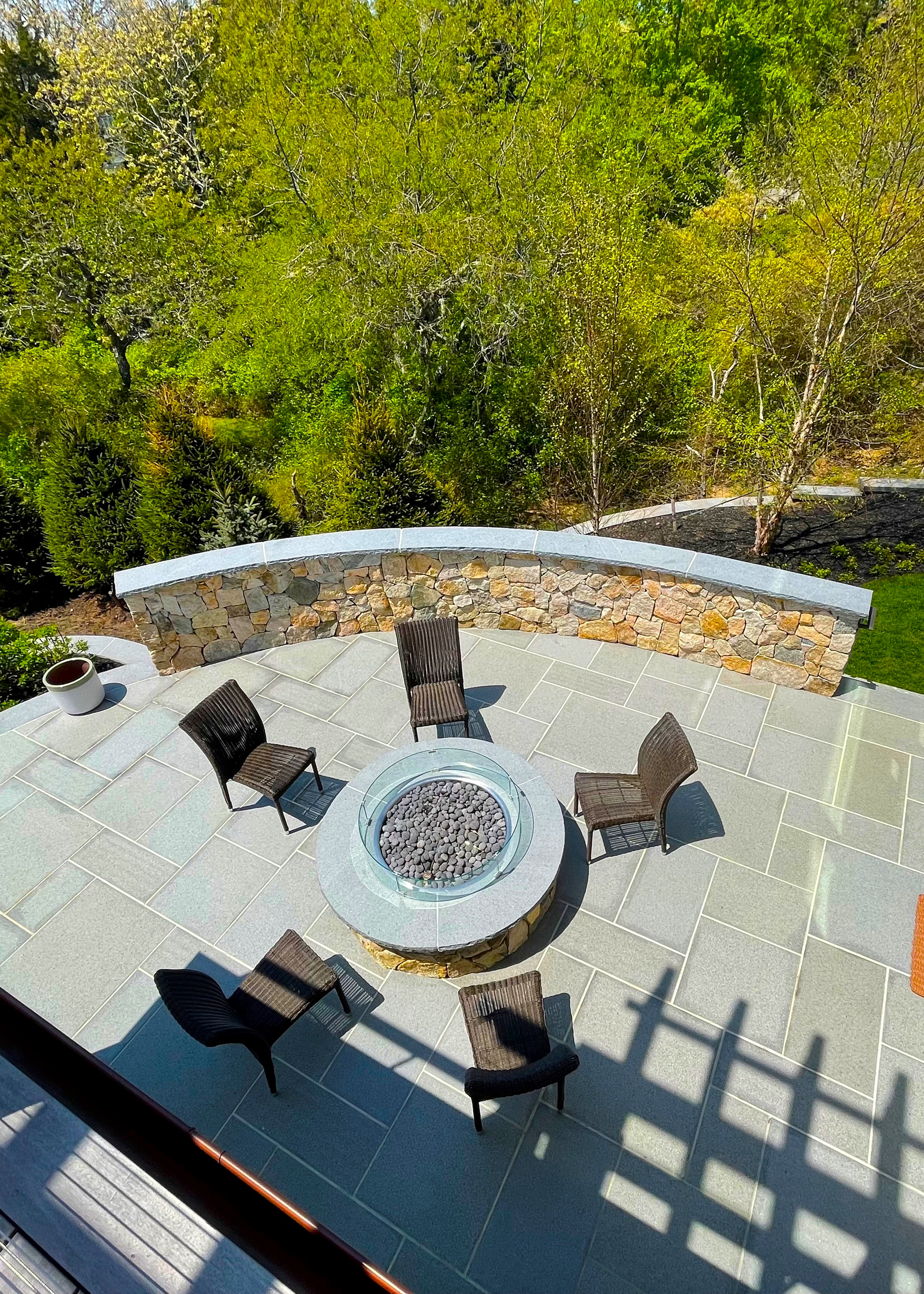 looking down on terrace with fire pit from upper deck
